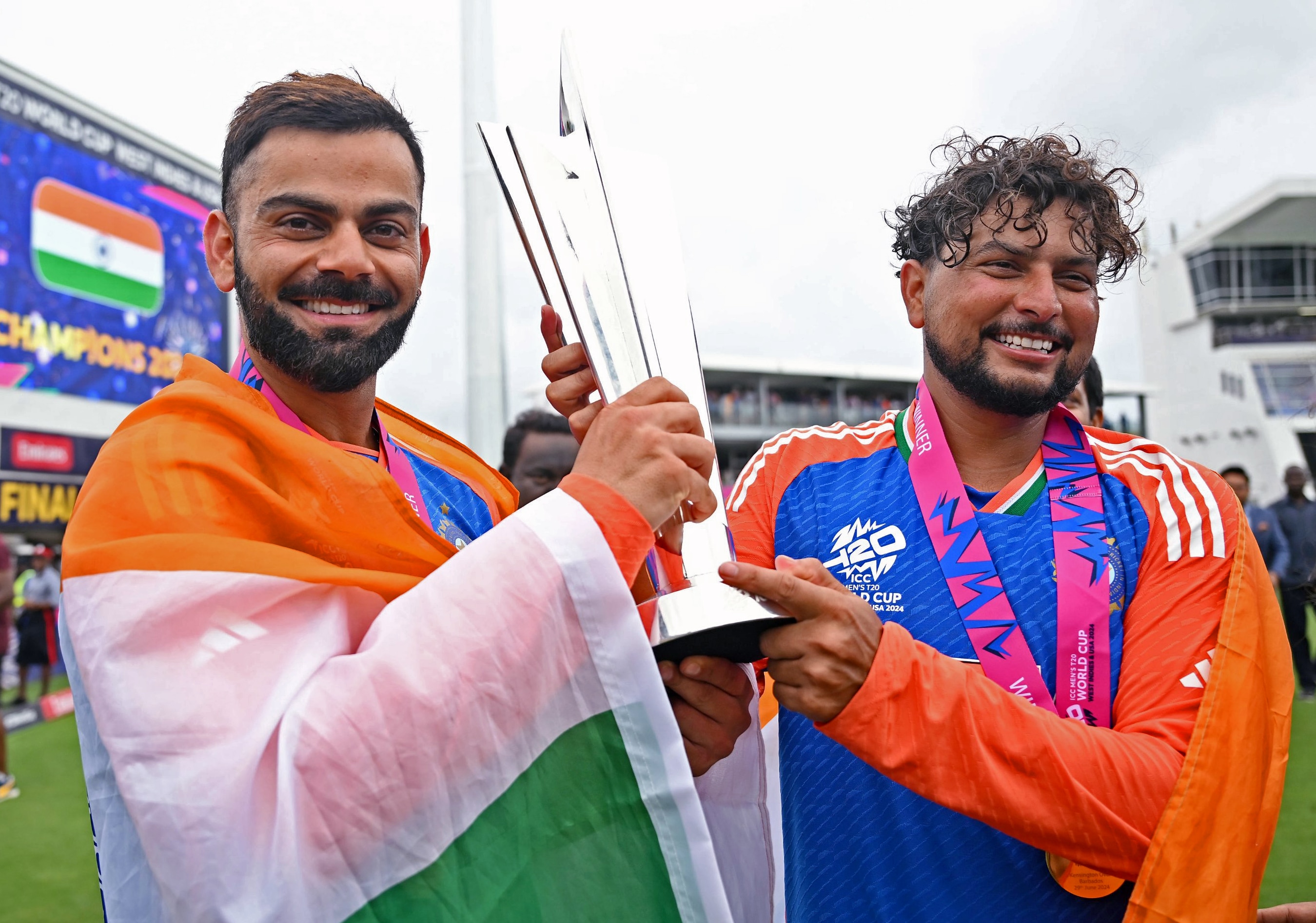 Barbados, Jun 30 (ANI): India's Virat Kohli and Kuldeep Yadav celebrate with the trophy after Team India wins the ICC Mens T20 World Cup 2024 final match against South Africa, at Kensington Oval in Barbados on Saturday. (ANI Photo) (BCCI-X)