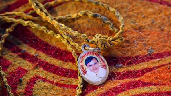 Hathras: A locket depicting Suraj Pal Singh aka Bhole Baba at the spot a day after a massive stampede that took place during a 'satsang' (religious congregation), in Sikandara Rao area in Hathras district, Wednesday, July 3, 2024. (PTI Photo) 