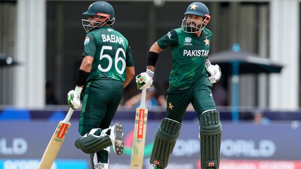 Pakistan's captain Babar Azam, left, and teammate Mohammad Rizwan run between the wickets during the ICC Men's T20 World Cup cricket match between Ireland and Pakistan at the Central Broward Regional Park Stadium, Lauderhill, Fla., Sunday, June 16, 2024. (AP Photo/Lynne Sladky)