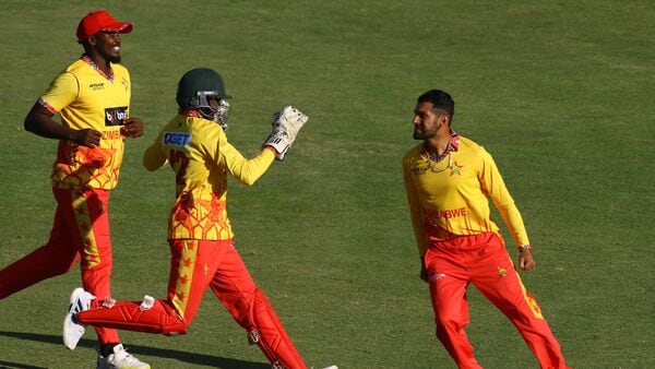Zimbabwe's Sikandar Raza (R) celebrates with teammates after the dismissal of India's Shubman Gill (unseen) during the first T20 international cricket match between Zimbabwe and India at Harare Sports Club in Harare on July 6, 2024. (Photo by Jekesai NJIKIZANA / AFP) (AFP)