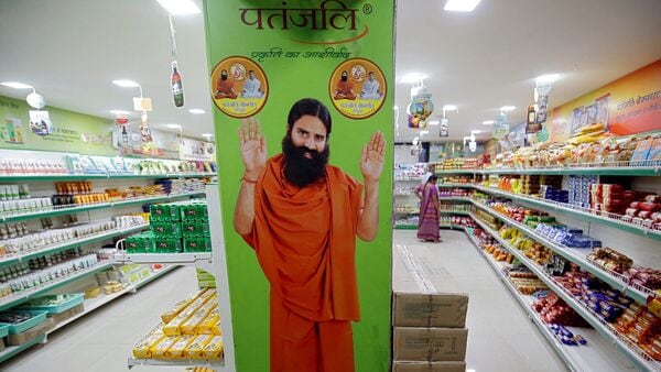 FILE PHOTO: A hoarding with an image of Baba Ramdev is seen inside a Patanjali store in Ahmedabad