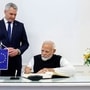 Prime Minister Narendra Modi signs the Guestbook at the Federal Chancellery, as Austrian Federal Chancellor Karl Nehammer looks on, in Vienna on Wednesday. 