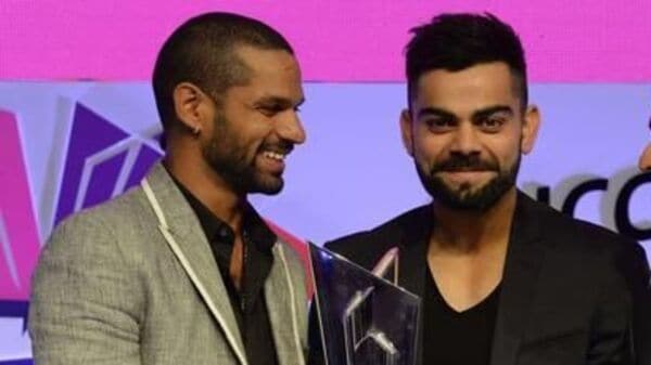 Indian cricketers Shikhar Dhawan, Virat Kohli and Ajinkya Rahane poses with the ICC World Twenty20 India 2016 trophy. Photo: AFP<br />