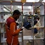 A gig worker picks up groceries for an order from a Swiggy's grocery warehouse at a market area in New Delhi, India, May 6, 2024. REUTERS/ (Priyanshu Singh/Reuters)