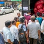 People queue up to buy onions from a mobile van as the sale of the kithcen staple at subsidised rates started in New Delhi on Thursday, (PTI Photo) (PTI)