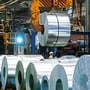 A coil of galvanised steel is transported by a coil grab crane at the manufacturing facility of Uttam Galva Steels, the Indian unit of ArcelorMittal, in Khopoli, Maharashtra. 