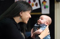 MSK patient Dana Vergara smiles as she holds her baby Hudson. 