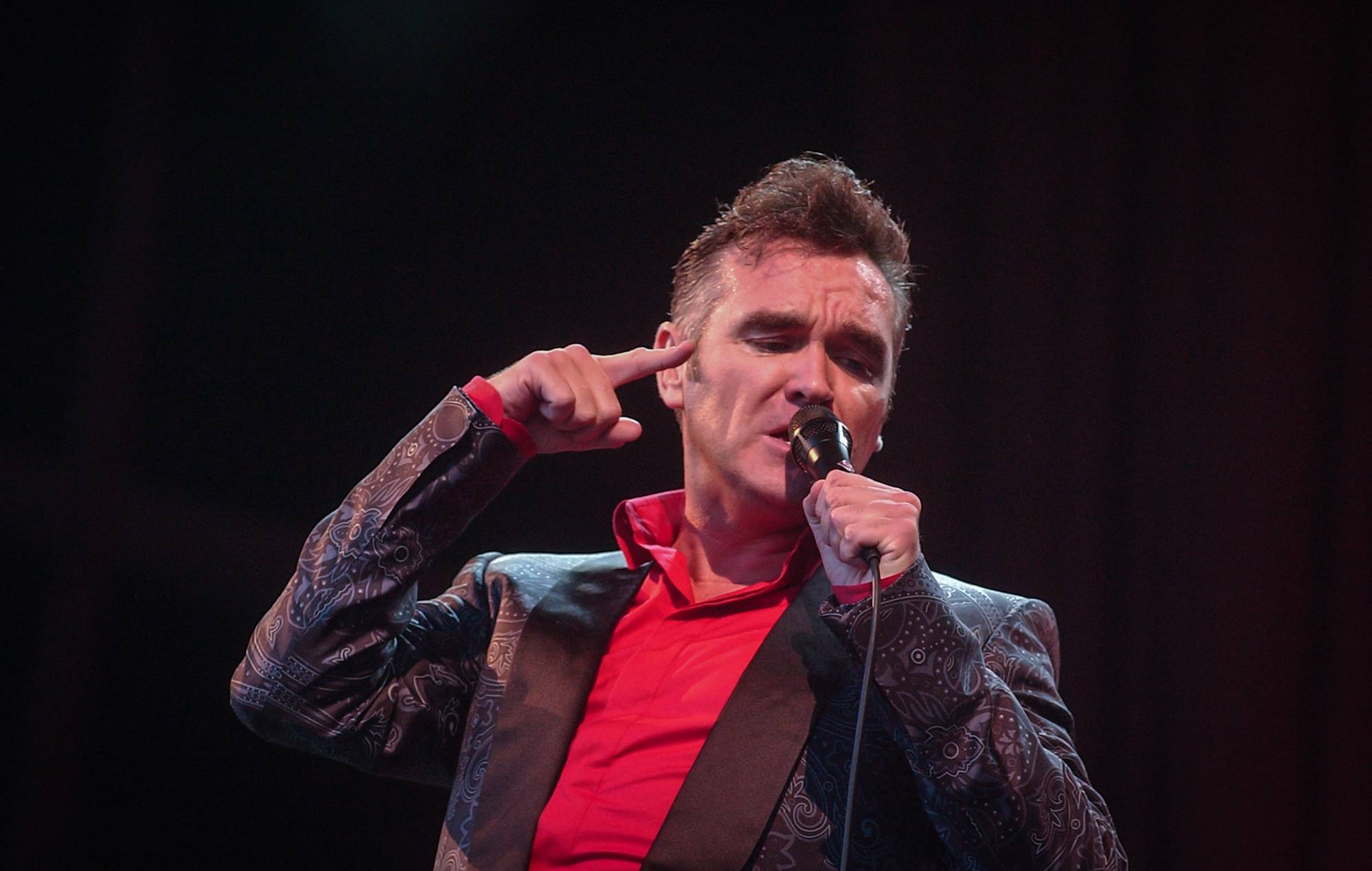 Morrissey performs on the main Pyramid Stage during the 2004 Glastonbury Festival being held at Worthy Farm, in Pilton, Somerset. Credit: Matt Cardy/Getty Images