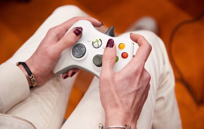 A visitor plays with an Xbox controller at the gaming fair Polaris Convention