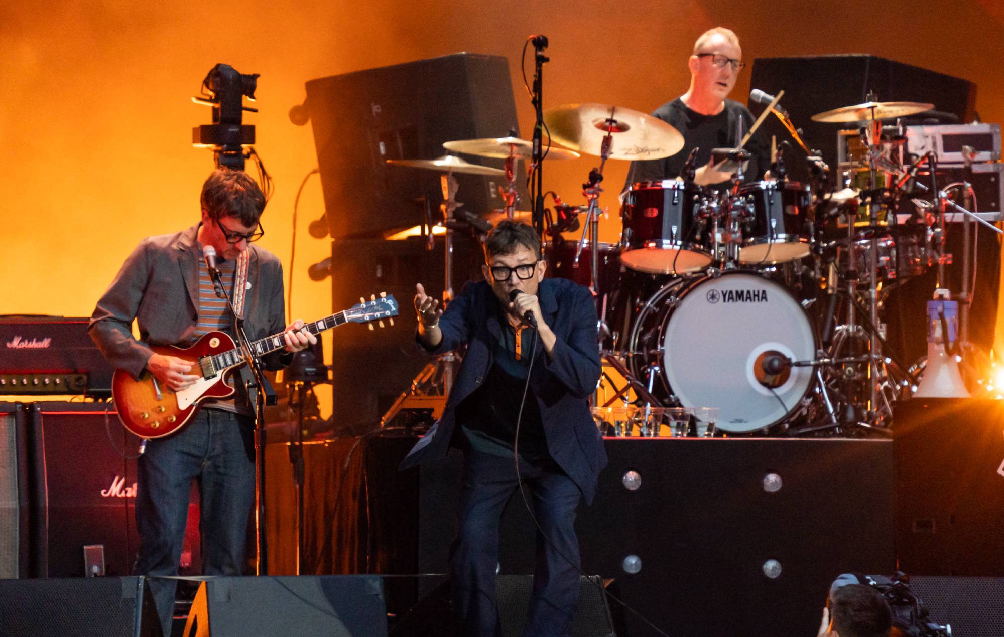 Graham Coxon, Damon Albarn and Dave Rowntree of Blur perform at Wembley Stadium (Photo by Lorne Thomson/Redferns)