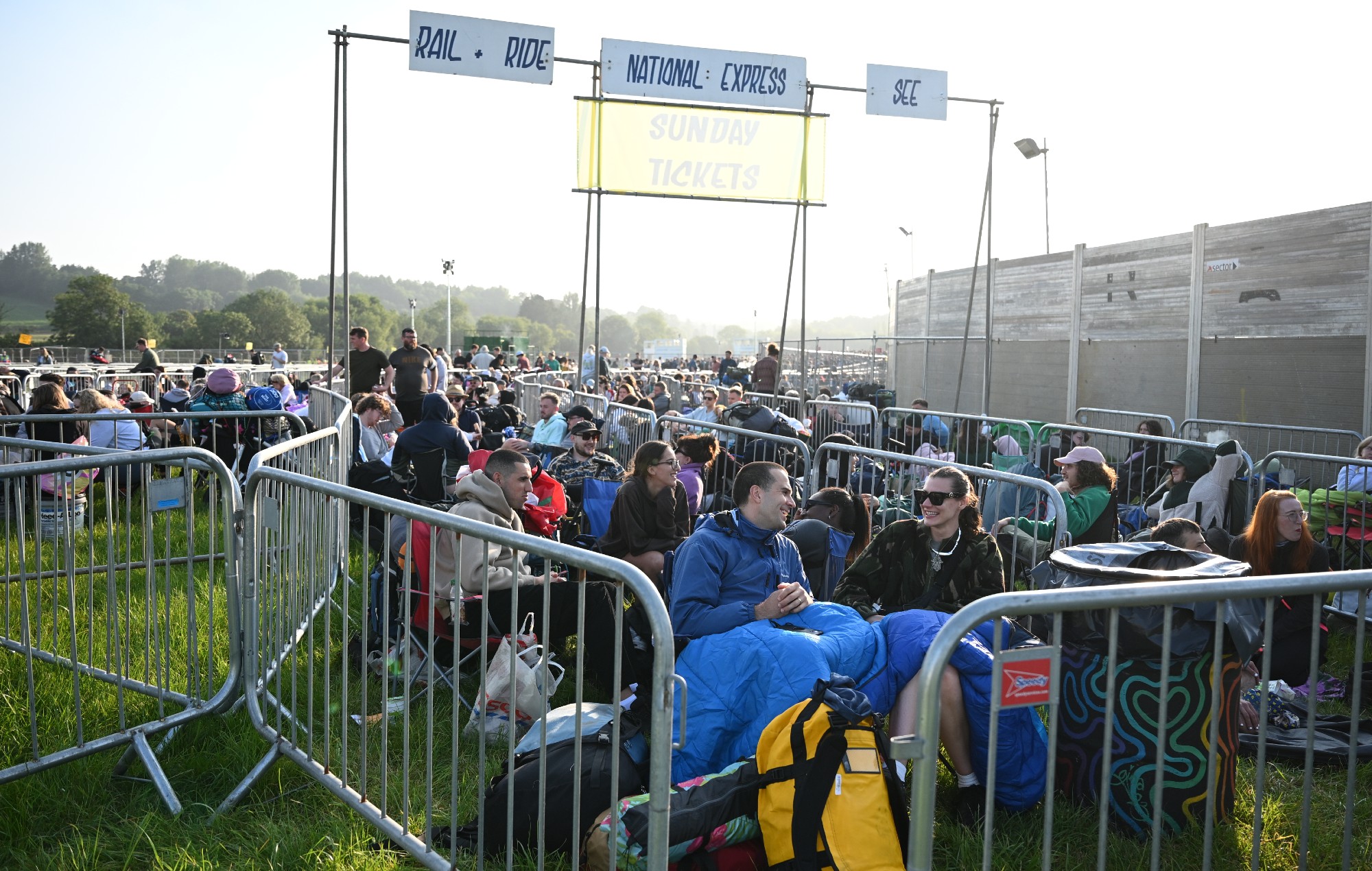 Visitors queue ahead of gates opening at 8am during day one of Glastonbury Festival 2024 at Worthy Farm