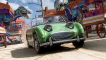 A classic green convertible races through festive streets, with two brightly painted T-rex sculptures posed in the background in Forza Horizon 5.