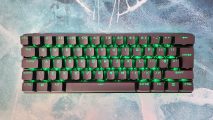 Corsair K70 Pro Mini Wireless review: A top-down view of the wireless gaming keyboard, with its RGB LEDs set to green