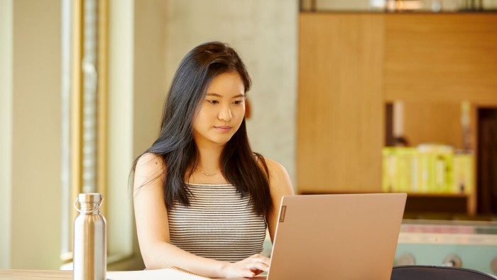 A student sat at home working from a laptop 