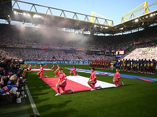 The standard-bearers at the opening ceremony of the soccer game.