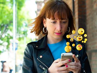 Young woman checking messages on her smartphone.