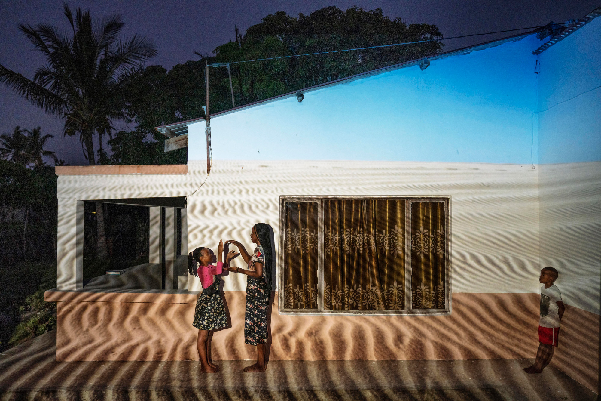 Kids playing in front of a house