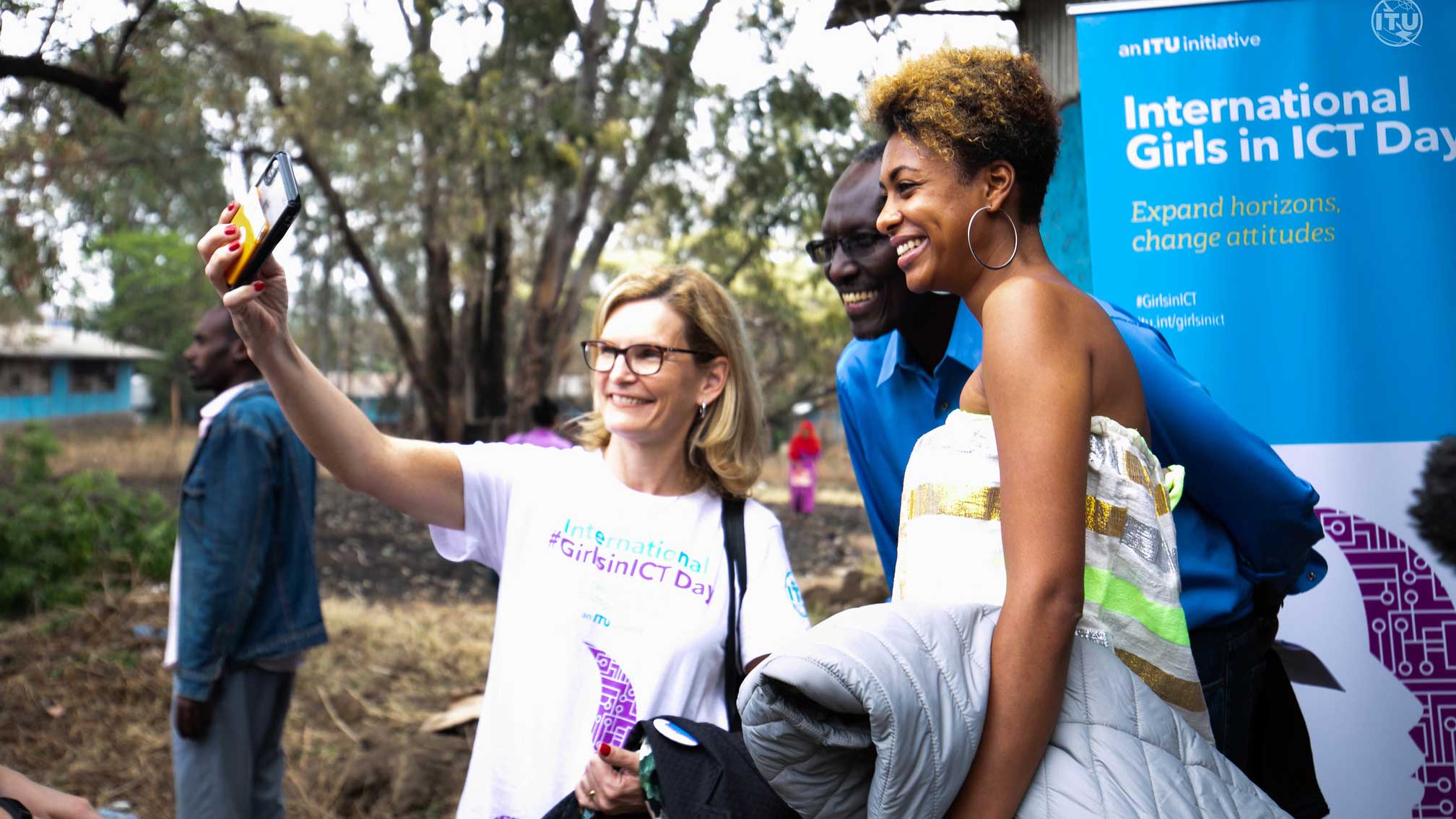 Doreen takes a selfie with a a woman and a man