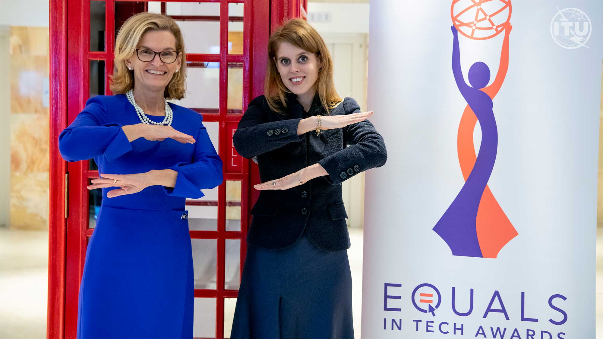 Doreen poses for a photo with a young woman and a poster behind them says Equals in Tech Award