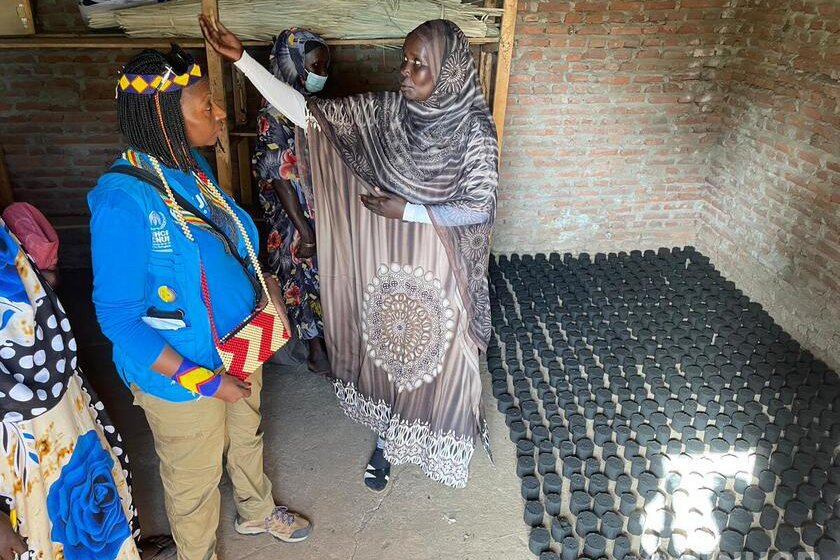 Juliette Murekeyisoni with another woman inside brick structure