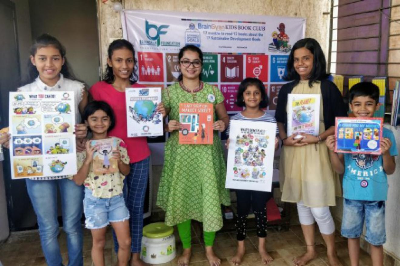 children holding up books