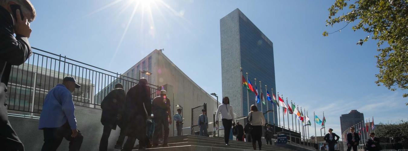 people are climbing steps to enter the New York UN building