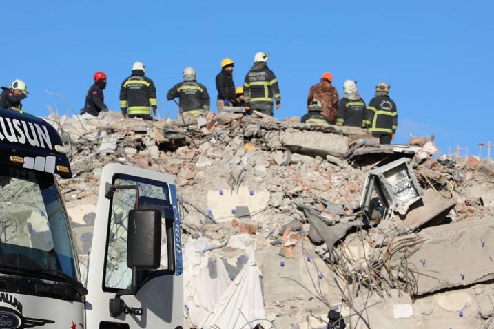 aid workers clearing earthquake rubble