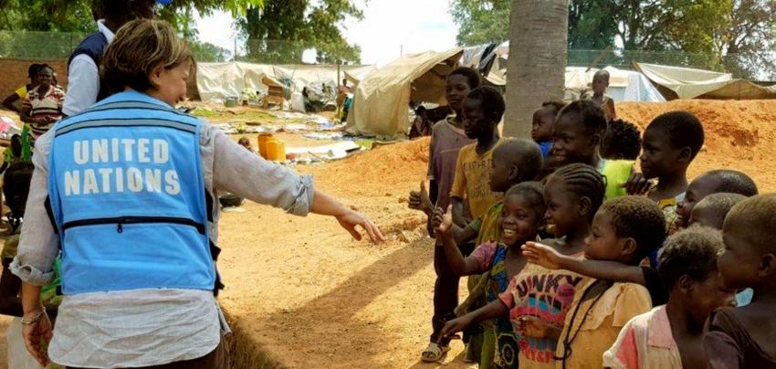 Woman greets children.