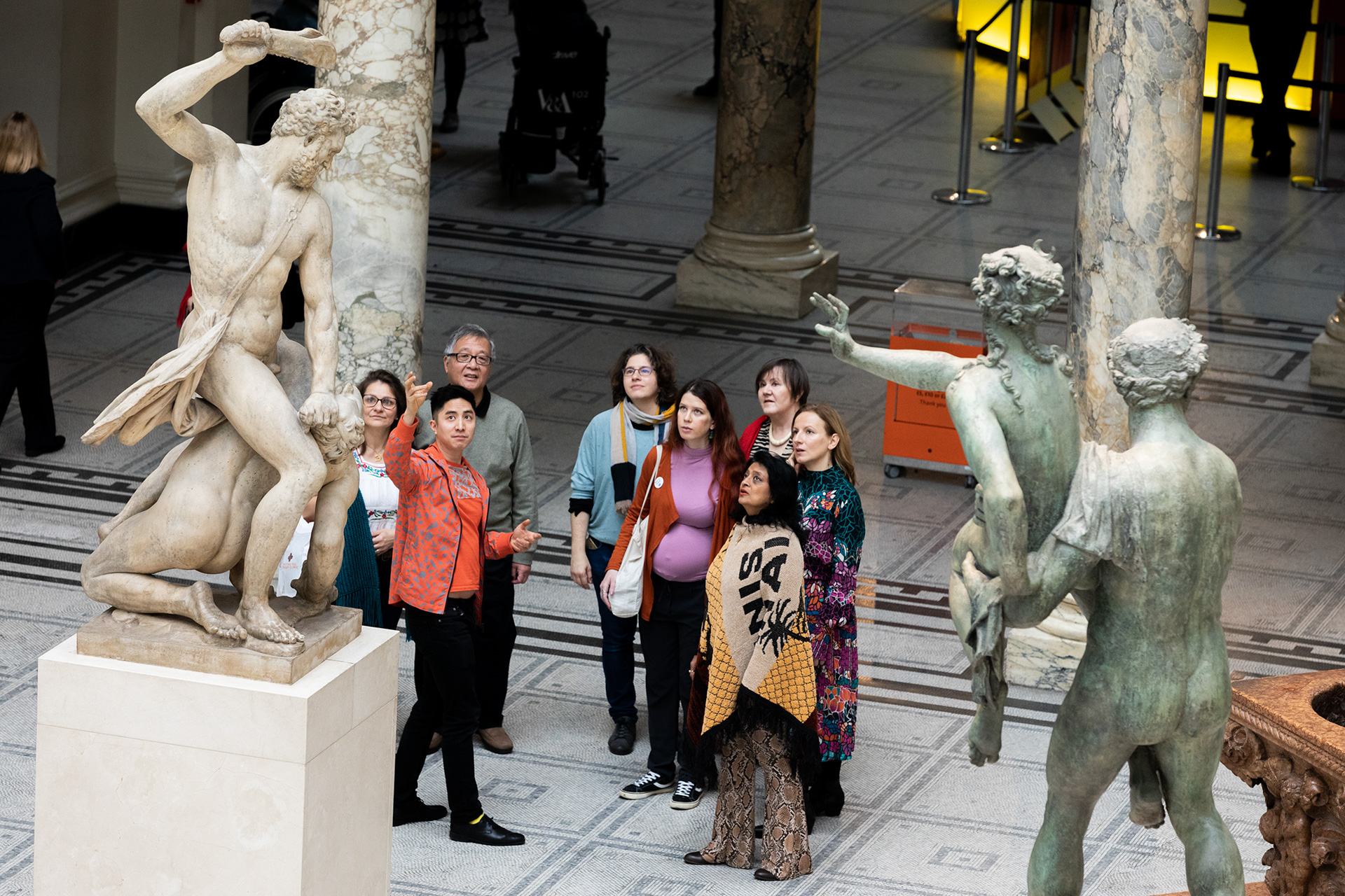 A tour group examines a sculpture at V&A South Kensington