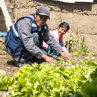 a father is working in the field with his daughter