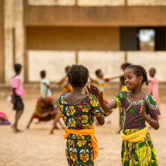 school girls are playing in the school garden