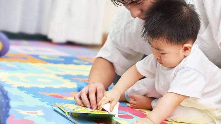 toddler playing with texture book